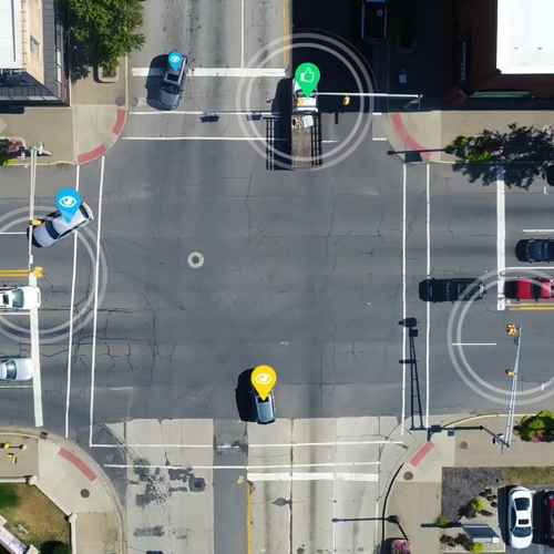 Aerial photo of a busy intersection with connected vehicle detection highlighting certain vehicles moving through the traffic signals. The link directs to the press release on the MEDC website.