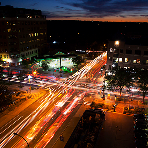 Aerial photograph of a downtown intersection at night. The link directs to the U-M press release.